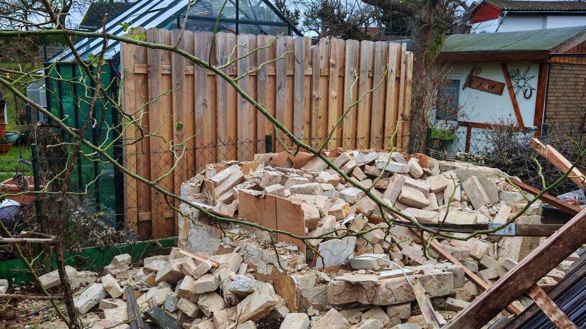 Abgebrochenes Nebengebäude, Ziegel und Holz liegen getrennt
